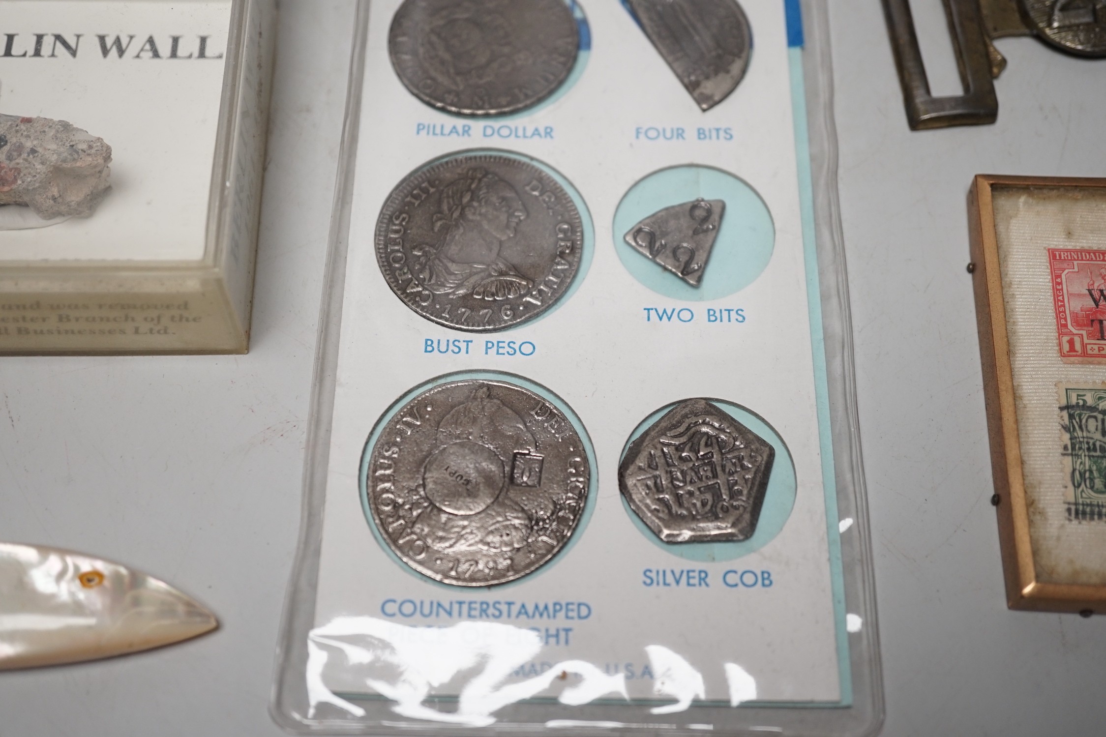 A collection of collectibles: a mother of pearl carves fish, a Mauchlin postal ruler, an enamel box and trays, coinage and various military badges etc